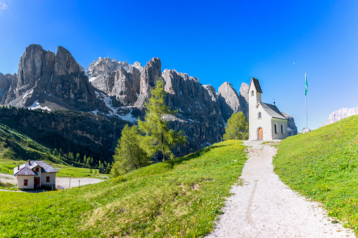 Tre Cime di Lavaredo peaks or Drei Zinnen at sunset, Dobbiaco Toblach, Trentino -Alto Adige or South Tyrol, Italy. Europe Alps. A couple of man and woman hiking in the Dolomites July 2021