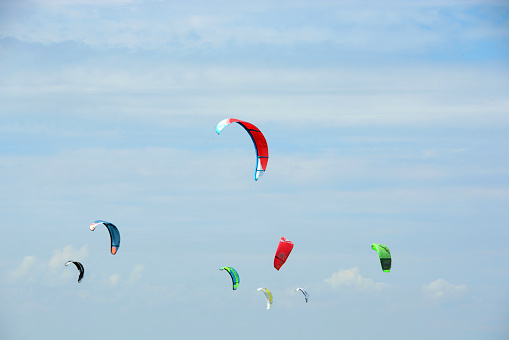 Netherlands ,lake ijsel:  june 22 - 2020 Group of colorfull power kite flying in the sky.  Visible power kite brands.