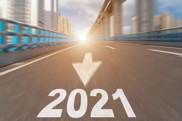 istock 2021 text on motion blurred asphalt road in modern city. 1253013827