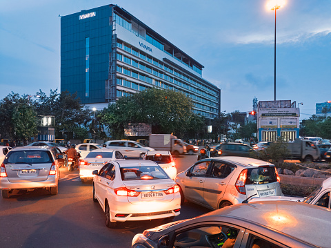 Ruby More, Kolkata, 6/25/2020: Rush hour traffic waiting at a traffic signal in evening, during which most office going people are returning home. WIth Unlock 3.0, most offices have resumed work.