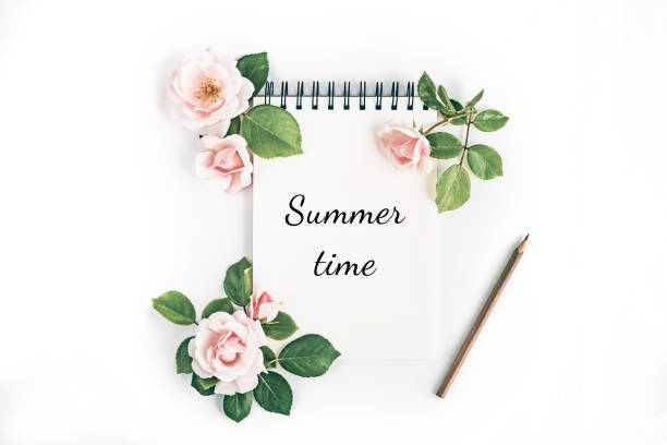 istock Notepad with pencil and flowers. 1253017509