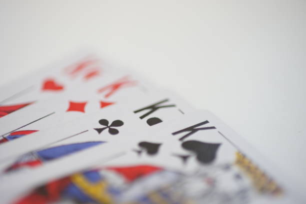Side view of kings cards on a white table.