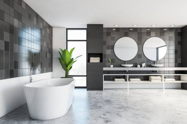 istock Gray and white tile bathroom with tub and sink 1253018490