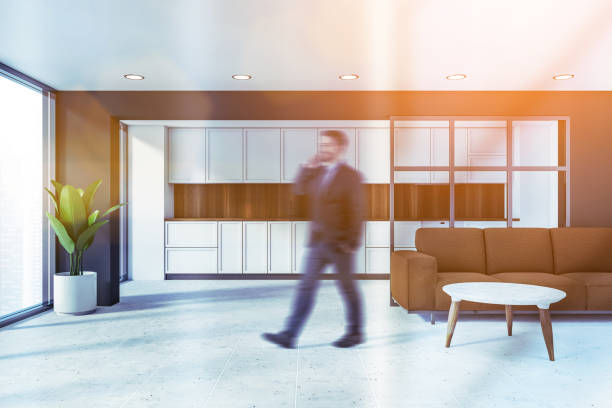 istock Man walking in gray living room and kitchen 1253019643