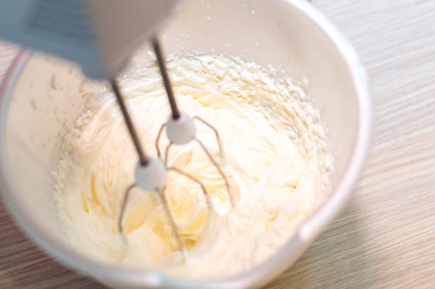 Mixer whips cream cake. Close-up. Close up stock photo