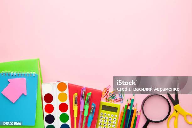 School equipment. Frame of school supplies on pink background