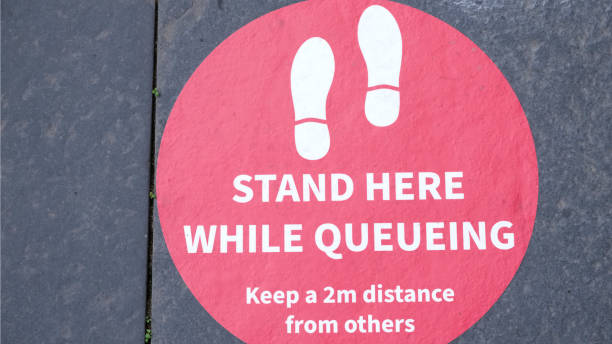 istock Social distancing sign for shop customer queue 1253024175
