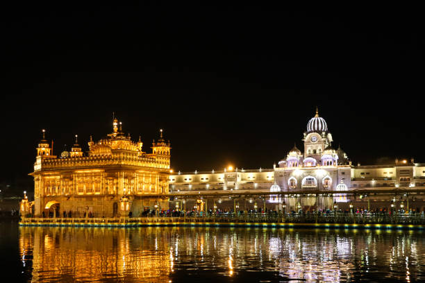 istock golden temple with reflection in the water at night 1253026133