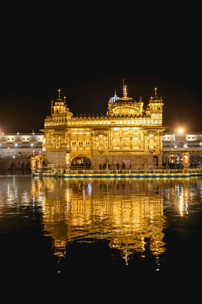 istock golden temple with reflection in the water at night 1253026247