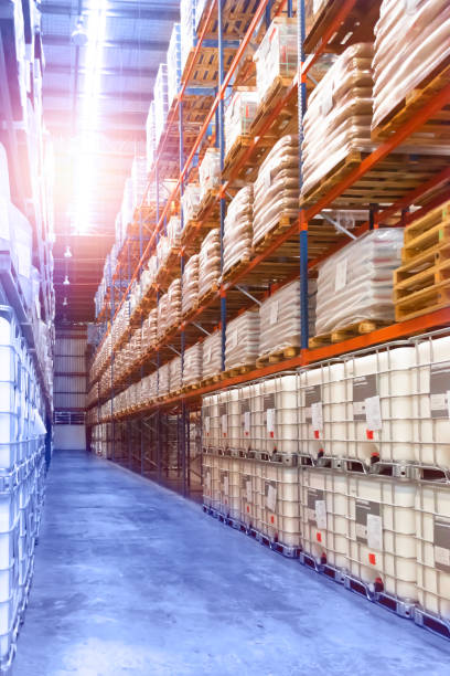 istock Large distribution warehouse interior, pallets and boxes of cargo stack on row of high shelves. 1253029026