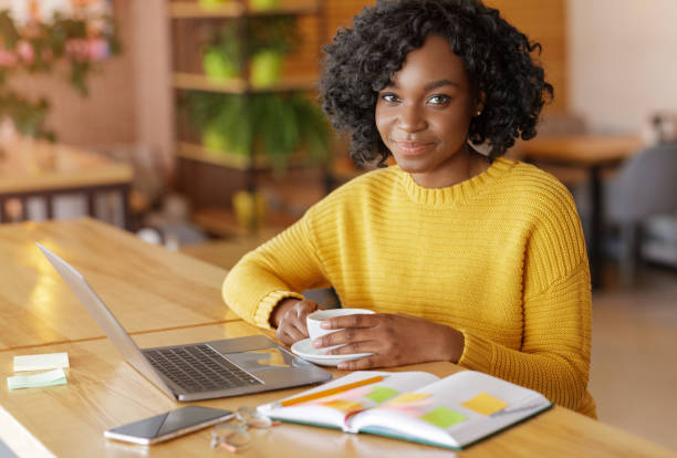 istock Creative female freelancer having coffee break, working at cafe 1253029091