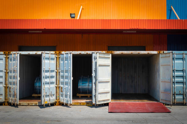istock Steel coils container stuffing for export, steel coils on wooden pallets inside container. Steel product import export. Container stuffing and unstuffing. 1253029129