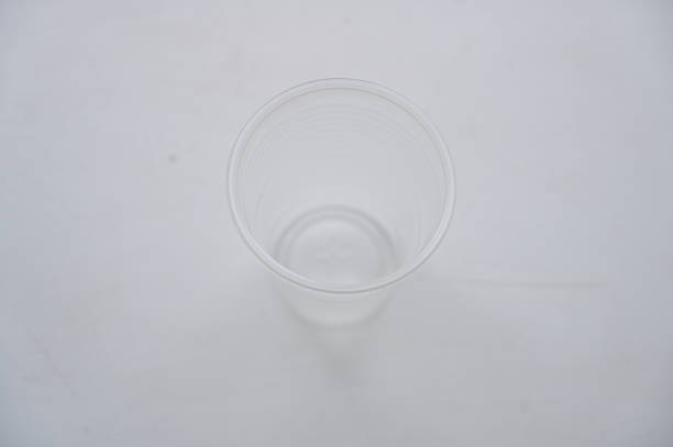 istock Concept Photo of plastic glass white table 1253030449