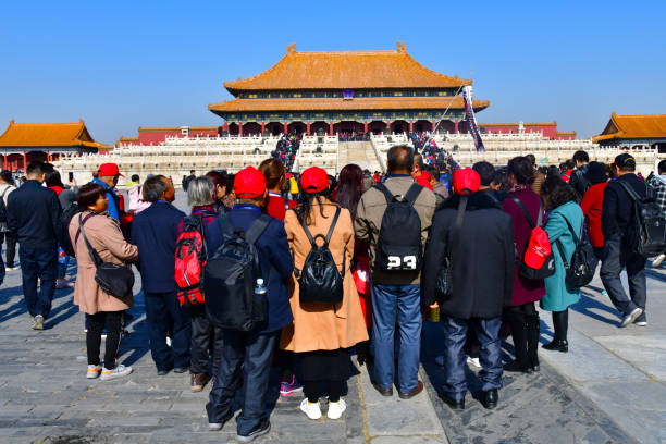 China, Beijing - September 23, 2025 : The Palace Museum in Beijing displays an ancient building. Many tourists are on tours of this historical site. A grand facade shows the rich architecture.