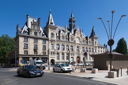 Charleville-Mézières, France - June 25 2020: The City Hall of Mézières was rebuilt in 1930 after the bombings of November 1918. The front facade of this building, of remarkable architecture, incorporates elements of medieval, Renaissance and Baroque style. Its impressive size is justified by the idea that the City Hall of Mézières will eventually become that of the 6 merged municipalities known today under the name of Charleville-Mézières.