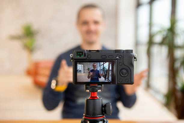 istock Man blogger telling something to his audience. 1253032975