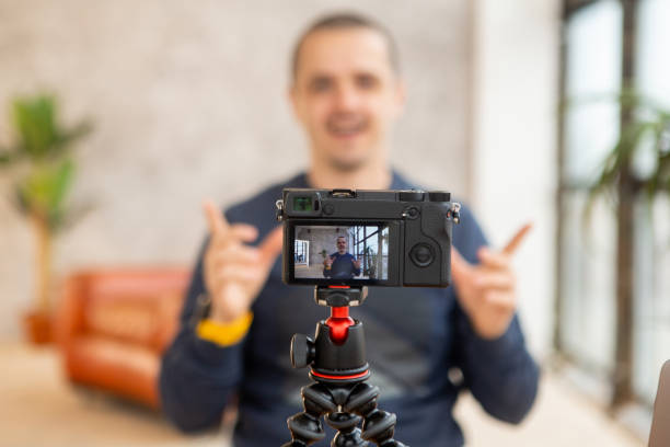 istock Man bloger recording video for his videoblog. 1253033059
