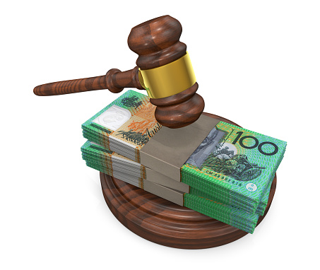 Judge gavel and stack of Australian dollar bills