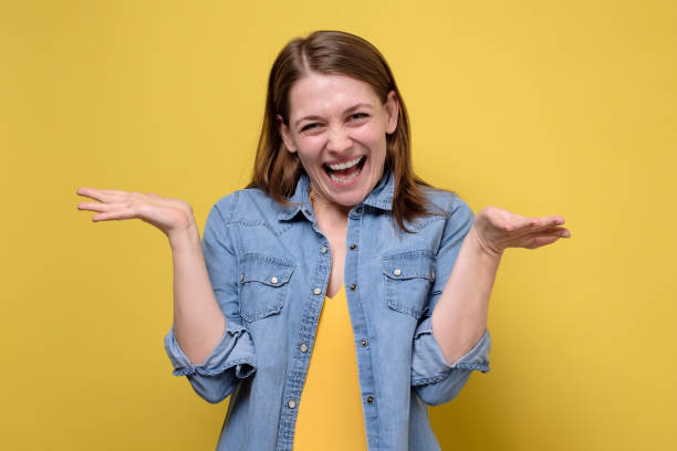 istock Smiling caucasian woman, spreading hands, showing on both sides, showing all variants 1253034448
