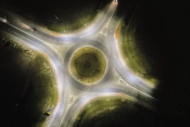 Empty roundabout road with street lights above drone view