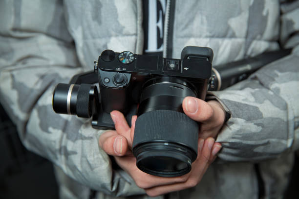 istock Man holding gimbal stabilizer outdoor. Gimbal Operator with black equipament - Stabilizer and camera filmmaking . An unidentified man holding gimbal a camera stabilizer . 1253041105