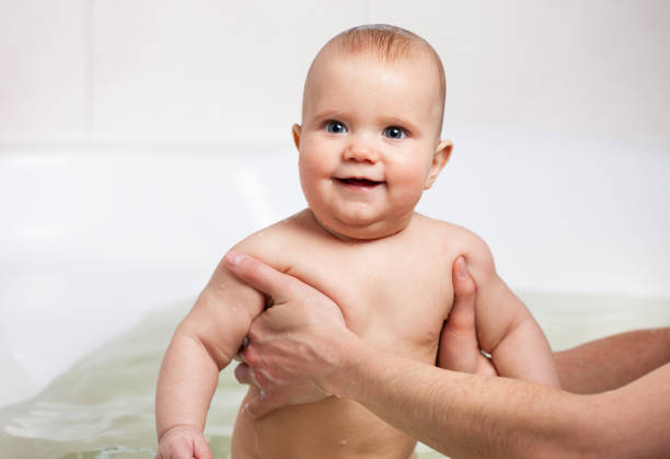istock Hands of a careful unknown mother hold boy 1253042756