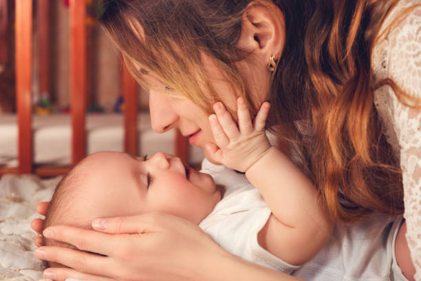 Happy mom plays with her young son. Harmony and love between mother and son