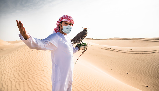 falcon man with face mask in uae