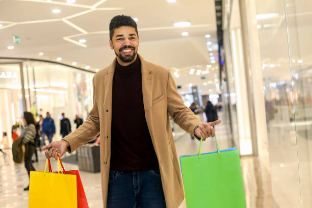 istock Smiling man in a shopping mall 1253045462