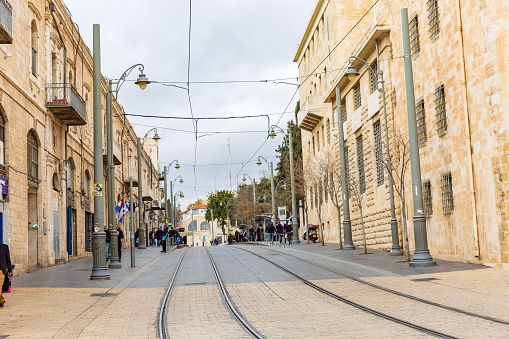 This pic shows the main and famous street Jaffa Street in jerusalem city. People walking and Jerusalem Light Rail tram track is seen in pic on Jaffa road. The pic is taken in day time and January 2019.