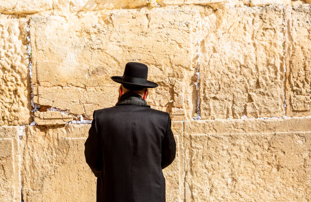 Men praying at Jerusalem's Western Wall This pic shows Jewish men pray at the Western Wall. Also called the Wailing Wall, it is the holiest site in Judaism. rabbi photos stock pictures, royalty-free photos & images