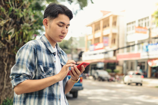 istock Asian man waiting for taxi 1253046768