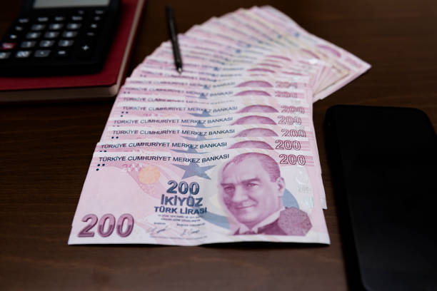 200 Turkish lira ranked , pencil , calculator 200 Turkish liras regularly arranged on the table Close-up Turkish Lira banknotes and coins circulation , calculator para birimi stock pictures, royalty-free photos & images