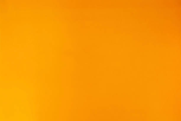 istock Orange blurred background. Orange abstract gold background yellow color, light corner spotlight, faint orange vintage background 1253051368