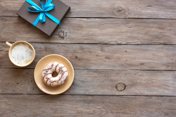 istock Fresh coffee, donut and gift box 1253051742