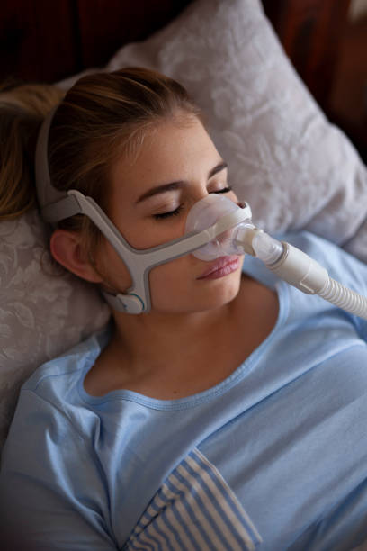 Sleeping with cpap machine stock photo