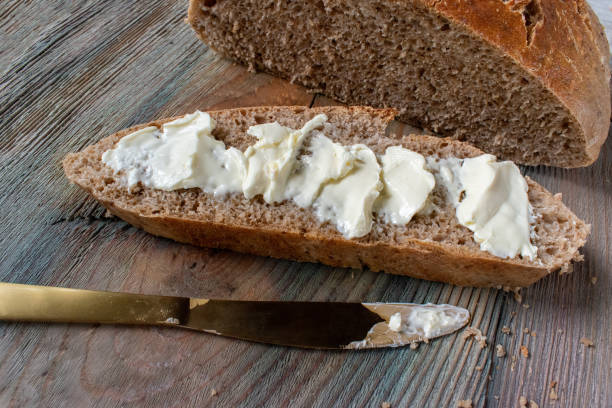 istock sliced wheat sourdough bread loaf with buttered slice 1253053026