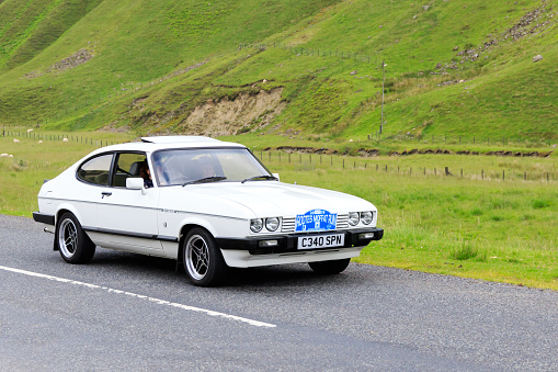 Moffat, Scotland - June 29, 2019: 1985 Ford Capri Injection car in a classic car rally en route towards the town of Moffat, Dumfries and Galloway