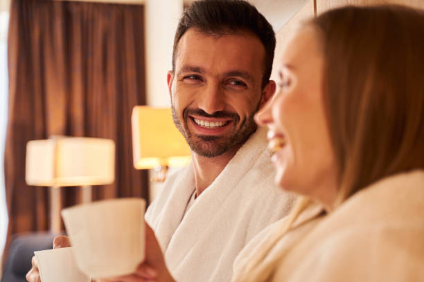 istock Happy man drinking coffee with beloved wife 1253056691