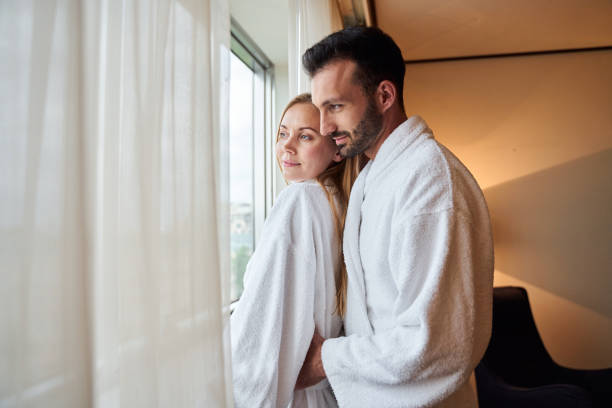 istock Happy young lovers hugging in light bedroom 1253056700