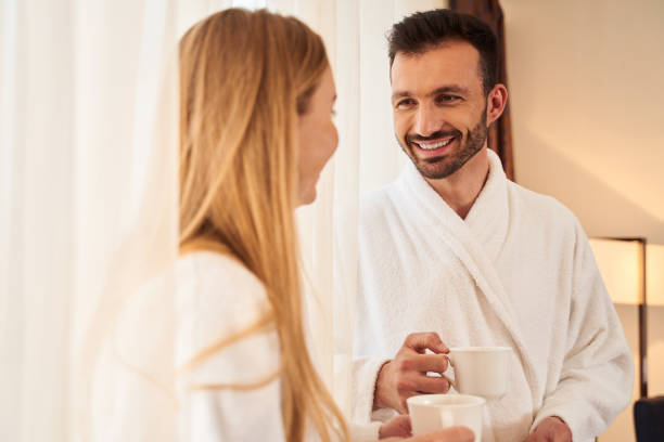 istock Happy man enjoying cup of coffee with girlfriend 1253056706