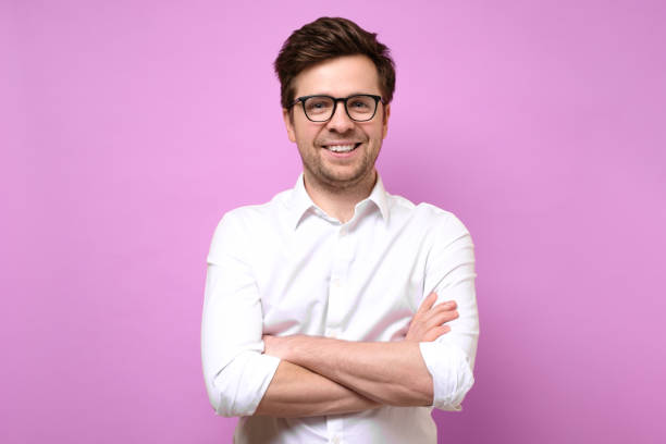 istock Happy coworker guy standing with arms folded, smiling 1253059116
