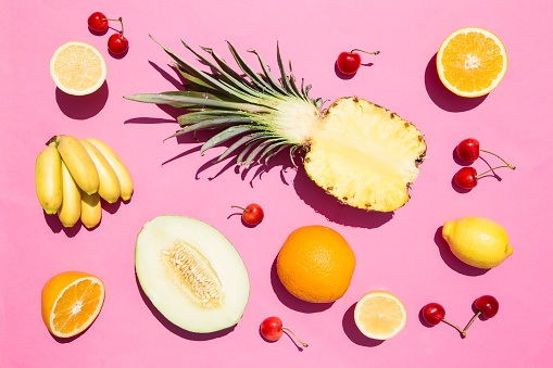 Tropical fruit on pink background