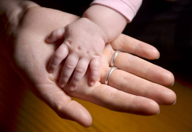 istock Baby's hand and mother's hand 1253060200