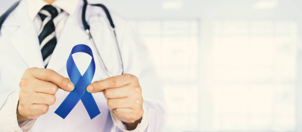 istock Doctor Holds Blue Ribbon 1253063365