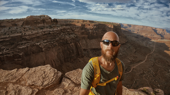 Man selfie video while hiking in the majestic desert landscapes of USA: outdoors adventures