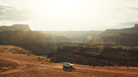 Drone view: flying over a off road car at the Shafer trail Canyonlands