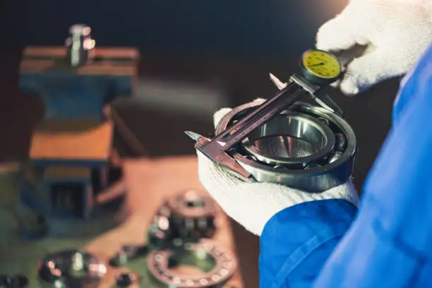 the abstract image of the technician maturing the ball bearing in the industrial factory. the concept of clean energy, futuristic, industrial4.0 and internet of things.