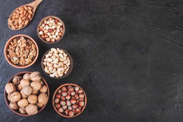 istock Different nuts in dishes, walnuts, hazelnuts, cashews and almonds 1253064813