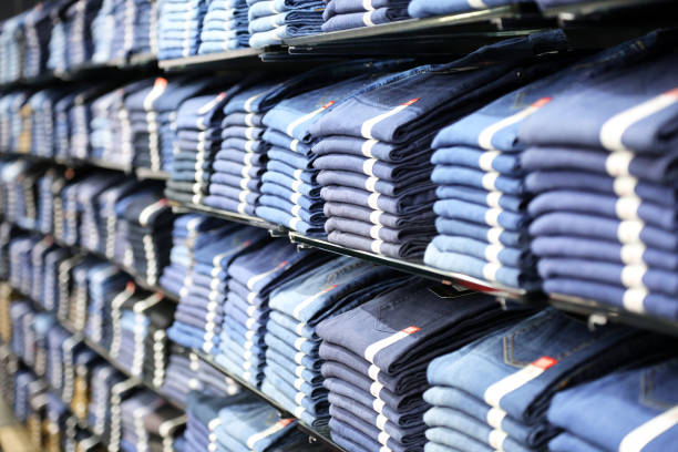 istock Assortment of clothes on a shelf in a store. 1253067421